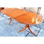 A REGENCY STYLE TWIN PEDESTAL MAHOGANY DINING TABLE with additional leaf, 105cm deep 216cm long