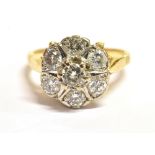 AN 18CT GOLD DAISY DIAMOND RING the ring set with seven round cut diamonds, the principal