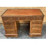 AN OAK TWIN PEDESTAL DESK with gilt tooled red leather inset top, 122cm wide 71cm deep 77cm high