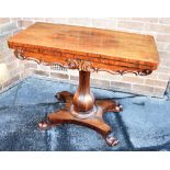 AN EARLY VICTORIAN ROSEWOOD CARD TABLE with carved decoration, on octagonal inverted baluster pillar