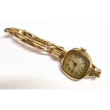 A VINTAGE 9CT GOLD CASED WRISTWATCH The watch with expandable yellow metal bracelet, inside case