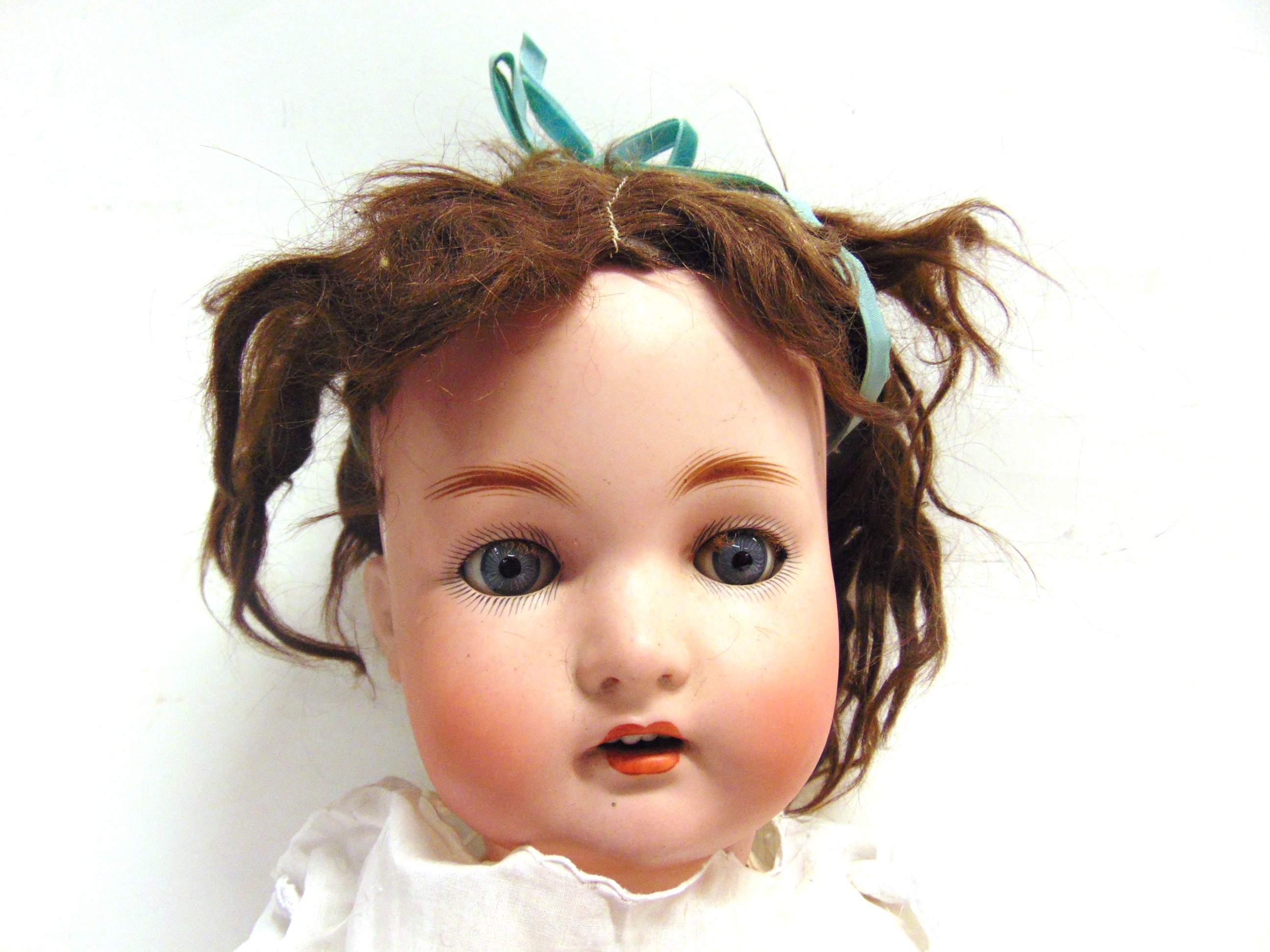 A GERMAN BISQUE SOCKET HEAD DOLL with a brown cropped wig, sleeping blue-grey glass eyes, and an - Image 2 of 2