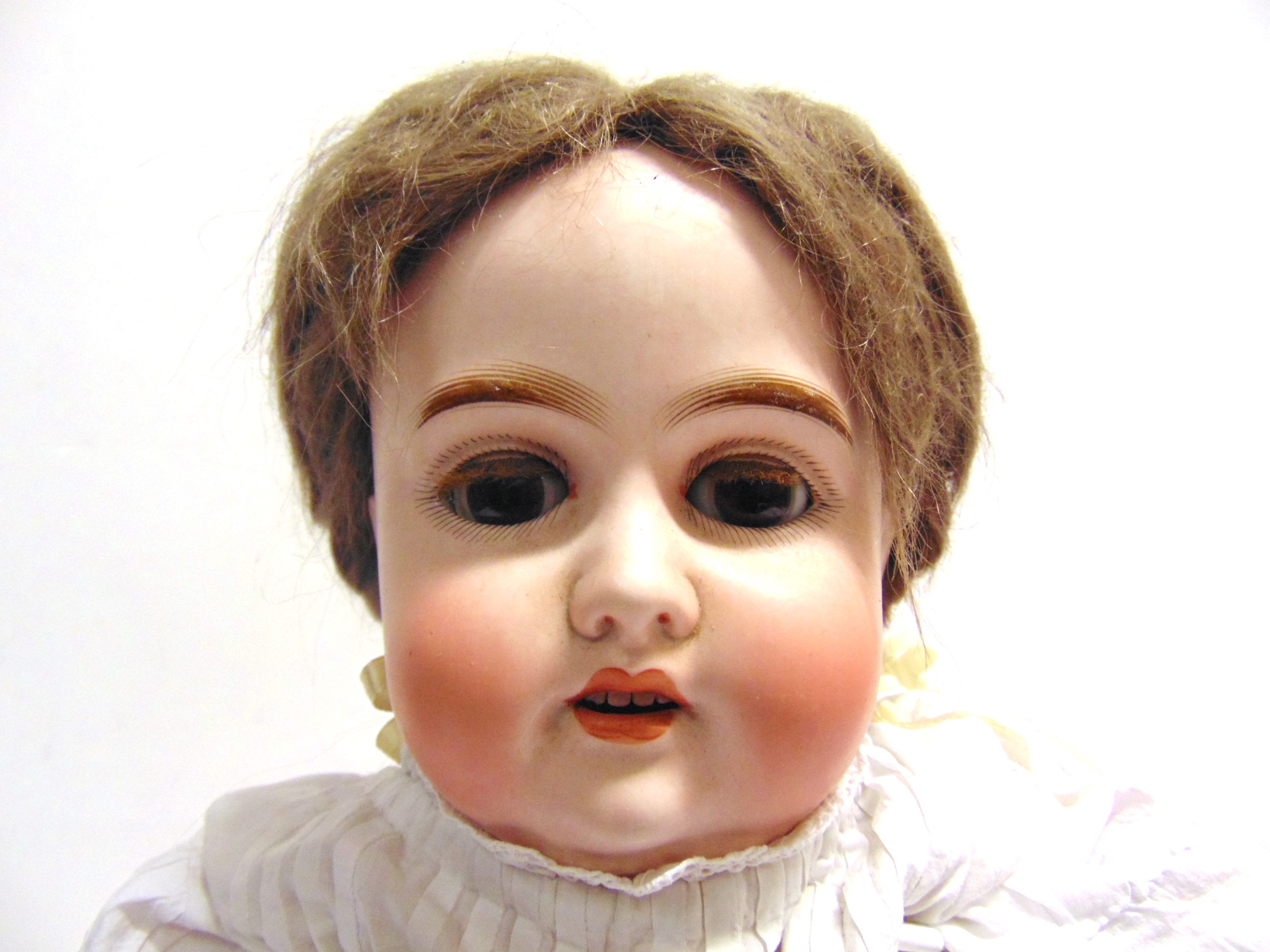 A GERMAN BISQUE SOCKET HEAD DOLL with a plaited brown wig, sleeping brown glass eyes, and an open - Image 2 of 2