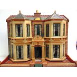 AN EARLY 20TH CENTURY DOLL'S HOUSE of predominantly painted wood construction, the double-fronted
