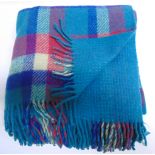 A WELSH WOOL REVERSIBLE FRINGED BLANKET in Royal blue, turquioise, fuscia and cream, labelled '