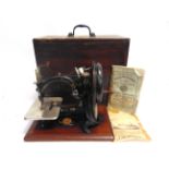 A WILLCOX & GIBBS SEWING MACHINE late 19th century, serial no.A473138, set to a wood base, overall
