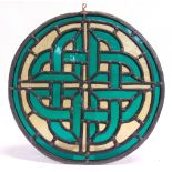A CELTIC KNOT CIRCULAR STAINED GLASS PANEL of emerald green and pale golden-brown glass, with a