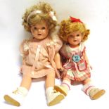 TWO IDEAL TOY CO. SHIRLEY TEMPLE COMPOSITION DOLLS each with a jointed body, the largest lacking