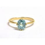 A STAMPED 18CT BLUE ZIRCON SOLITAIRE RING the aqua blue faceted oval zircon measuring 7 x 5 mm, ring