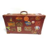 A BROWN LEATHER SUITCASE the lid interior with a stationery pocket, the base interior with twin