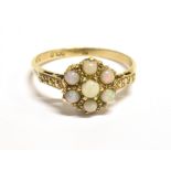 A VINTAGE OPAL FLOWER HEAD RING The flower head measuring 9mm in diameter, shank marked 9c gold,