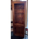 A LARGE FLOOR STANDING PITCH PINE CORNER SHELF CABINET with three shaped shelves above cupboard,