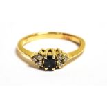 A STAMPED 585 DIAMOND AND SPINEL DRESS RING the midnight blue spinel centrally set and flanked