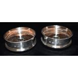 A PAIR OF SILVER COATED COASTERS The coasters of plain form with textured rim and tiered base