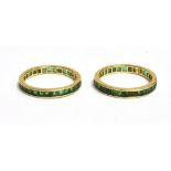A PAIR OF STAMPED 14K CALIBRE CUT EMERALD FULL ETERNITY RINGS the matched pair of rings with