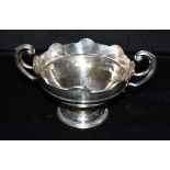 AN EDWARDIAN SILVER TROPHY CUP The cup with flying scroll handles, of plain form with a central