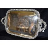 A VERY LARGE CIRCA 1900 SILVER PLATED TRAY the tray twin handled, on four claw feet with heavily