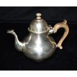 A GEORGE V SILVER TEAPOT the teapot of curved form, beaked spout with wood effect handle and knob,