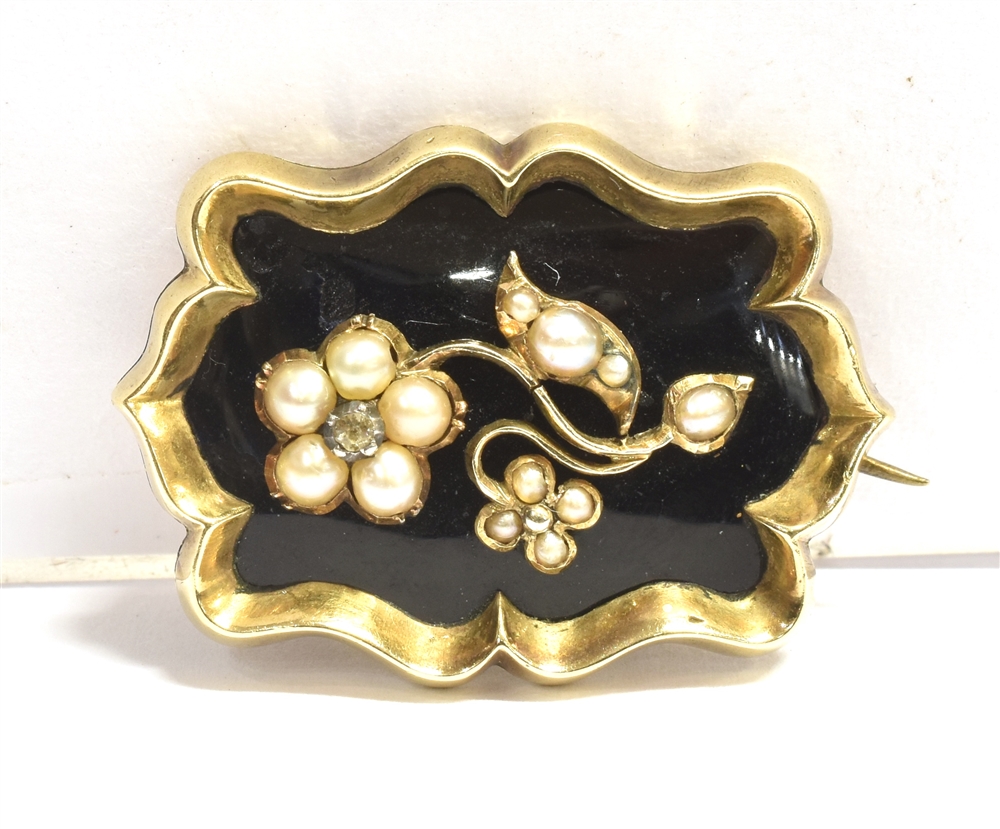 A VICTORIAN SEED PEARL AND ENAMEL MEMORIAL BROOCH the brooch in black enamel, featuring a floral