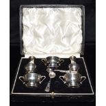 A CASED SET OF VICTORIAN SILVER CRUETS Comprising of two salts (blue glass liner) one lidded salt (