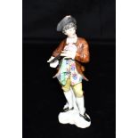 A CONTINENTAL HARD PASTE PORCELAIN FIGURE OF A MAN dressed in breeches and a floral waistcoat,