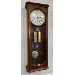 A CONTINENTAL TWIN WEIGHT MAHOGANY CASED WALL CLOCK with Westminster chime, 30cm wide 85cm high