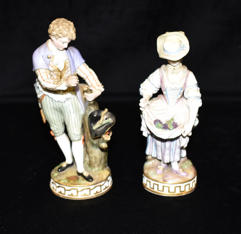 TWO 19TH CENTURY MEISSEN FIGURES: one of a lady gathering grapes in her apron, 17.5cm high; the