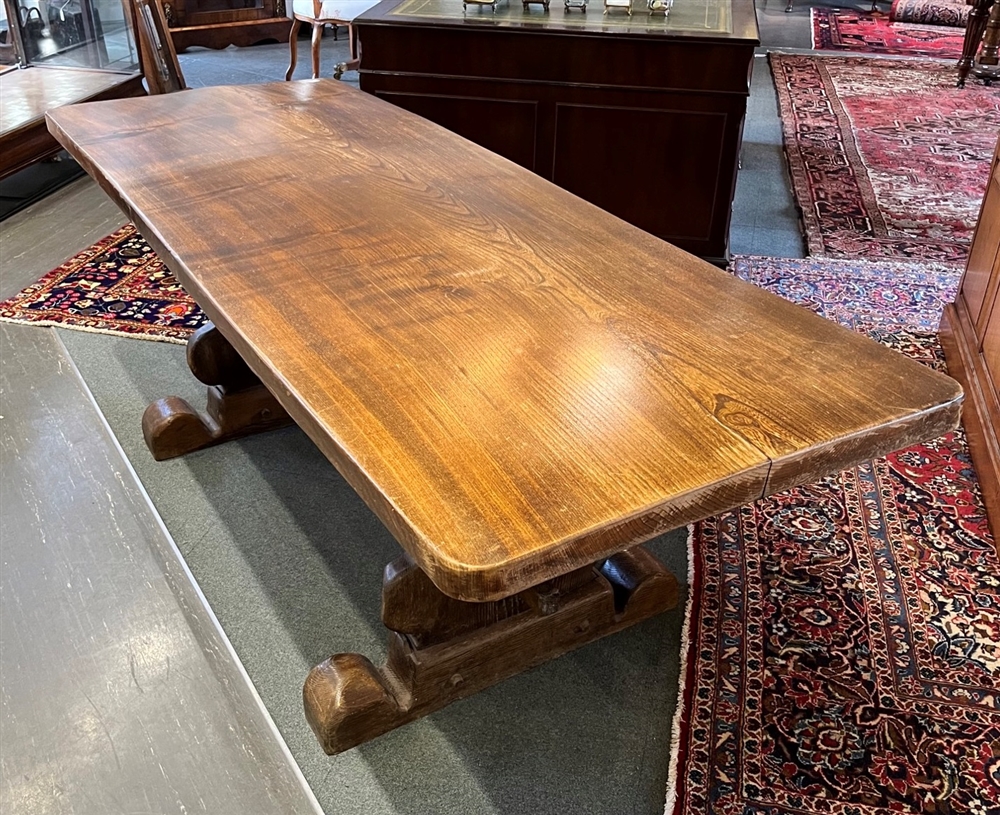 A REFRECTORY DINING TABLE the substantial single plank top 77cm wide, 212cm long, on shaped supports