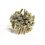 A WHITE AND YELLOW METAL VINTAGE STATEMENT RING the white metal ring of abstract design, with