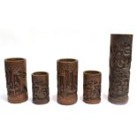 A GARNITURE OF FIVE CHINESE BAMBOO BRUSH POTS relief carved with scholars and buildings in a