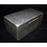 A SILVER CIGARETTE BOX The box of plain form with dated initial inscription to the lid, inlaid