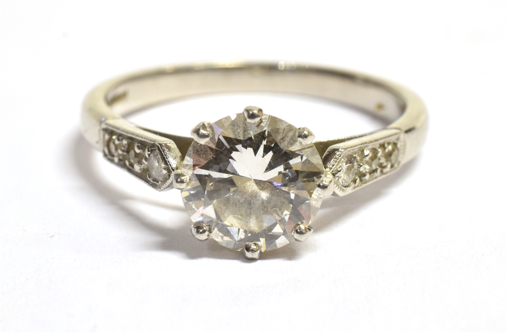 A PLATINUM AND EUROPEAN CUT DIAMOND RING The principal diamond, coronet set, with three old cut