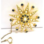 A 9CT GOLD, SAPPHIRE AND SEED PEARL STAR BURST BROOCH The brooch set with 16 sapphires and