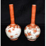 A PAIR OF JAPANESE KUTANI VASES decorated with birds and blossom, signed to base, 25cm high