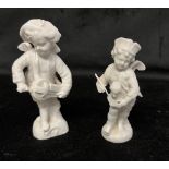 TWO BERLIN (KPM) BLANC DE CHINE FIGURES OF CHERUBS one playing a hurdy gurdy, 11cm high; the other