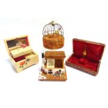 FOUR MUSICAL JEWELLERY OR TRINKET BOXES including one in the form of a cage with two birds, 18.5cm
