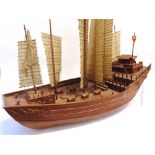 A MODEL OF A CHINESE JUNK of wooden construction, in full sail, 91cm long. Condition Report :