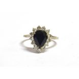 A STAMPED 18CT DIAMOND AND SAPPHIRE CLUSTER RING the facetted pear shaped sapphire measuring 10 x