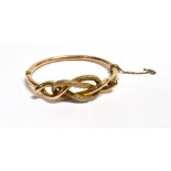 A VINTAGE MARKED 9CT EVERLASTING BANGLE the hinged bangle with half detached safety chain, working