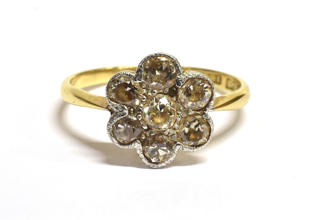 AN ART DECO DAISY DIAMOND RING The ring set with a daisy head comprising of transitional cut