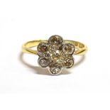 AN ART DECO DAISY DIAMOND RING The ring set with a daisy head comprising of transitional cut