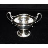 A SILVER TROPHY CUP Twin handled on pedestal foot hallmarked for London 1920 height to include
