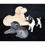 A FIGURE OF A STANDING BLACK AND WHITE SPANIEL A 'Sandicast' figure of a seated black Labrador and a