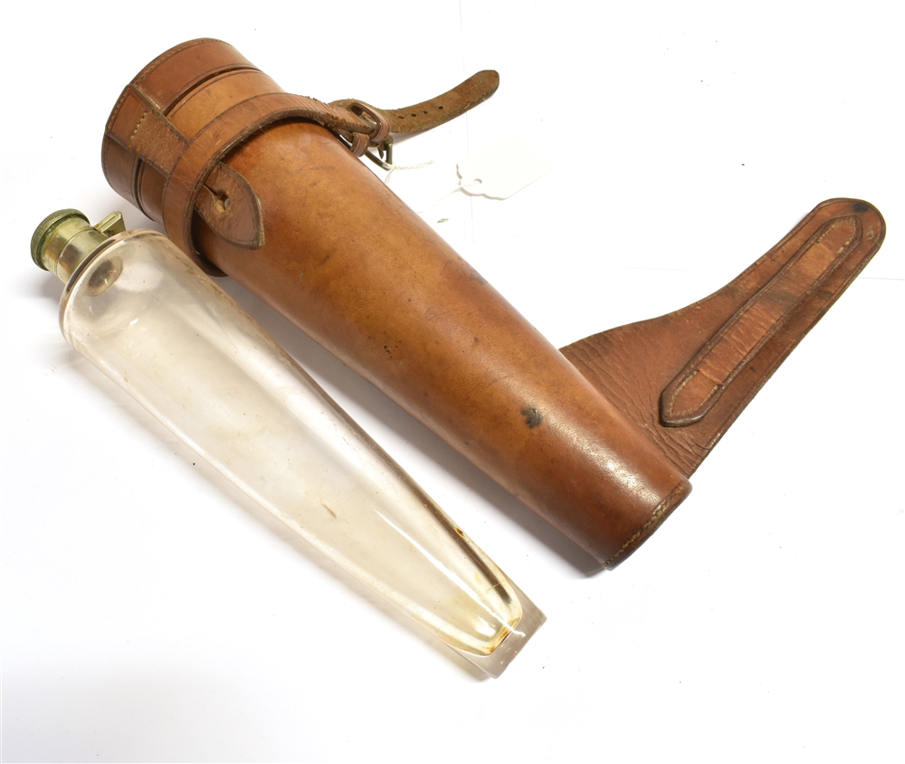 A TAPERED GLASS FLASK with plated flip top by Swaine & Adeney Ltd, London, in leather holder for