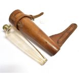 A TAPERED GLASS FLASK with plated flip top by Swaine & Adeney Ltd, London, in leather holder for