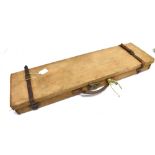A RECTANGULAR CANVAS COVERED GUN CASE With pair of leather fastening straps and carrying handle