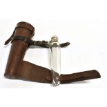 A TAPERED GLASS FLASK with plated flip top in leather holder for saddle mounting, 23cm