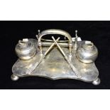 AN UNUSUAL SILVER PLATED CURLING DESK STAND The pair of inkwells in the form of curling stones,