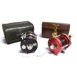 TWO ABU AMBASSADEUR 6000 FISHING REELS one red and one black, together with brown and black
