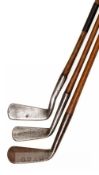 A group of 12 hickory shafted irons, comprising three smooth-faced clubs i) a Forgan Mashie smooth-